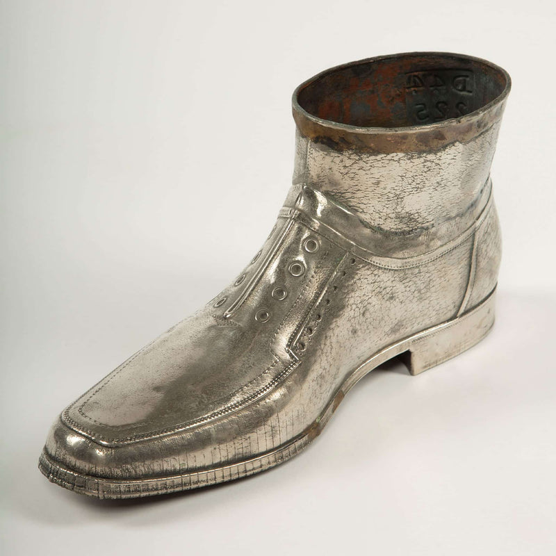Sculpted Sole: Novelty Metal Boot with Industrial Markings