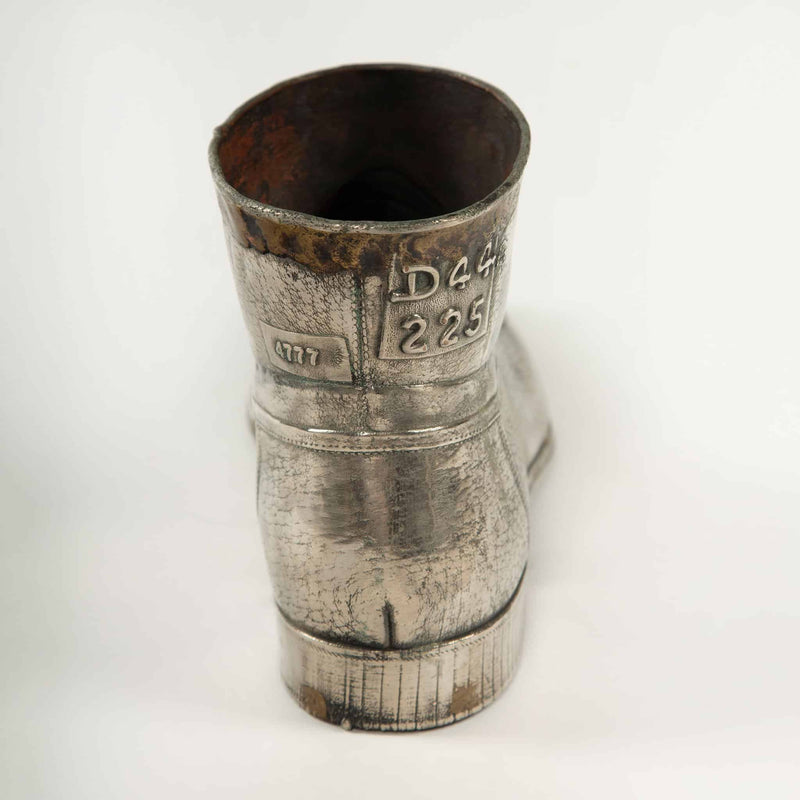 Sculpted Sole: Novelty Metal Boot with Industrial Markings