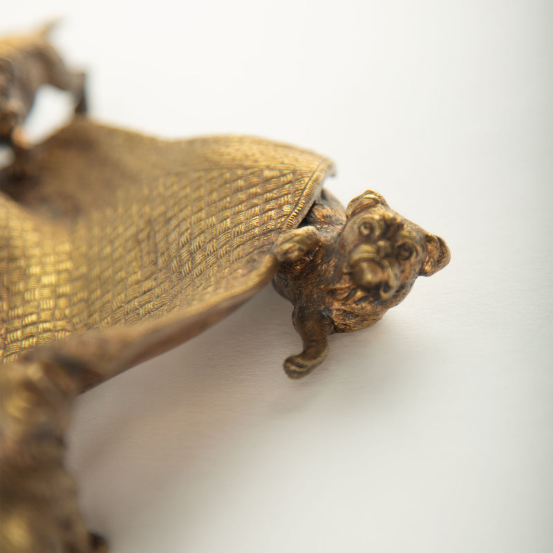 Tug of War: A Bronze Inkwell of Tugging Pugs on a Rug