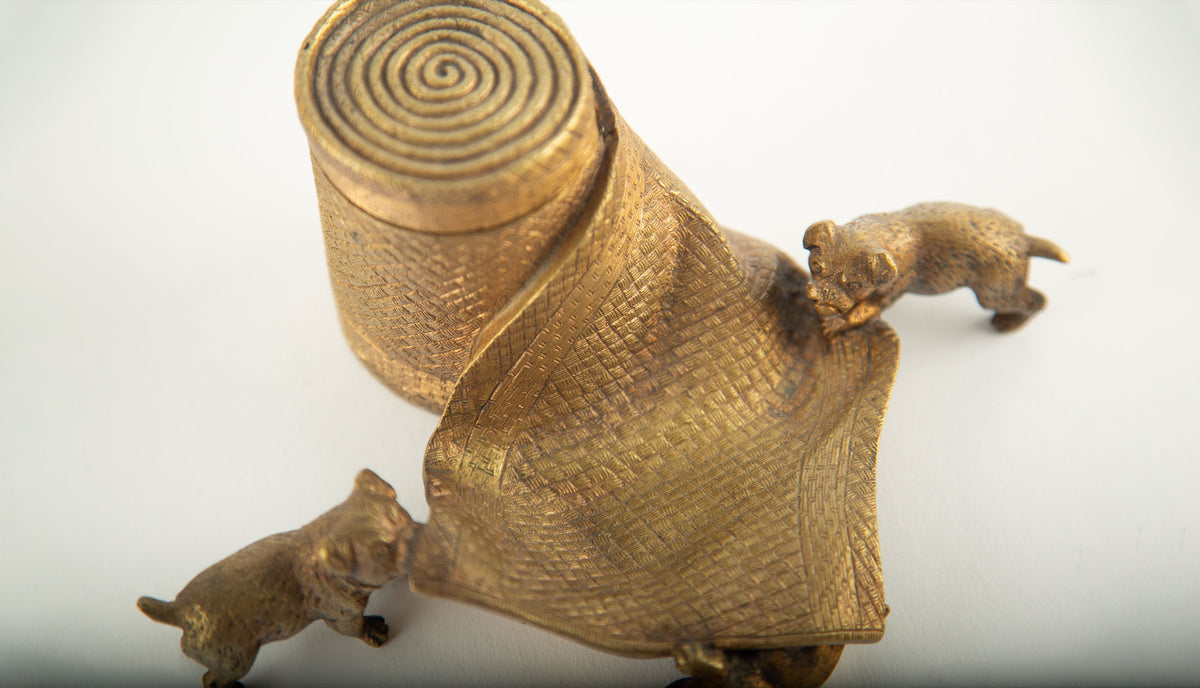 Tug of War: A Bronze Inkwell of Tugging Pugs on a Rug
